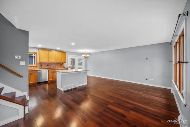a view of a kitchen with kitchen island and stainless steel appliances