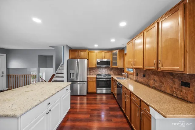 a large kitchen with a large window and stainless steel appliances