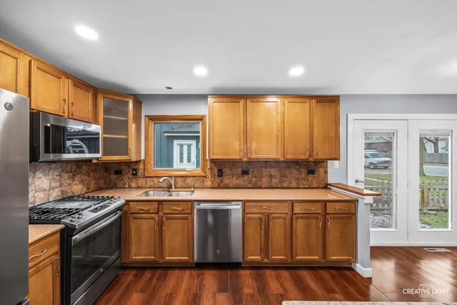 a kitchen with a stove a sink and a microwave