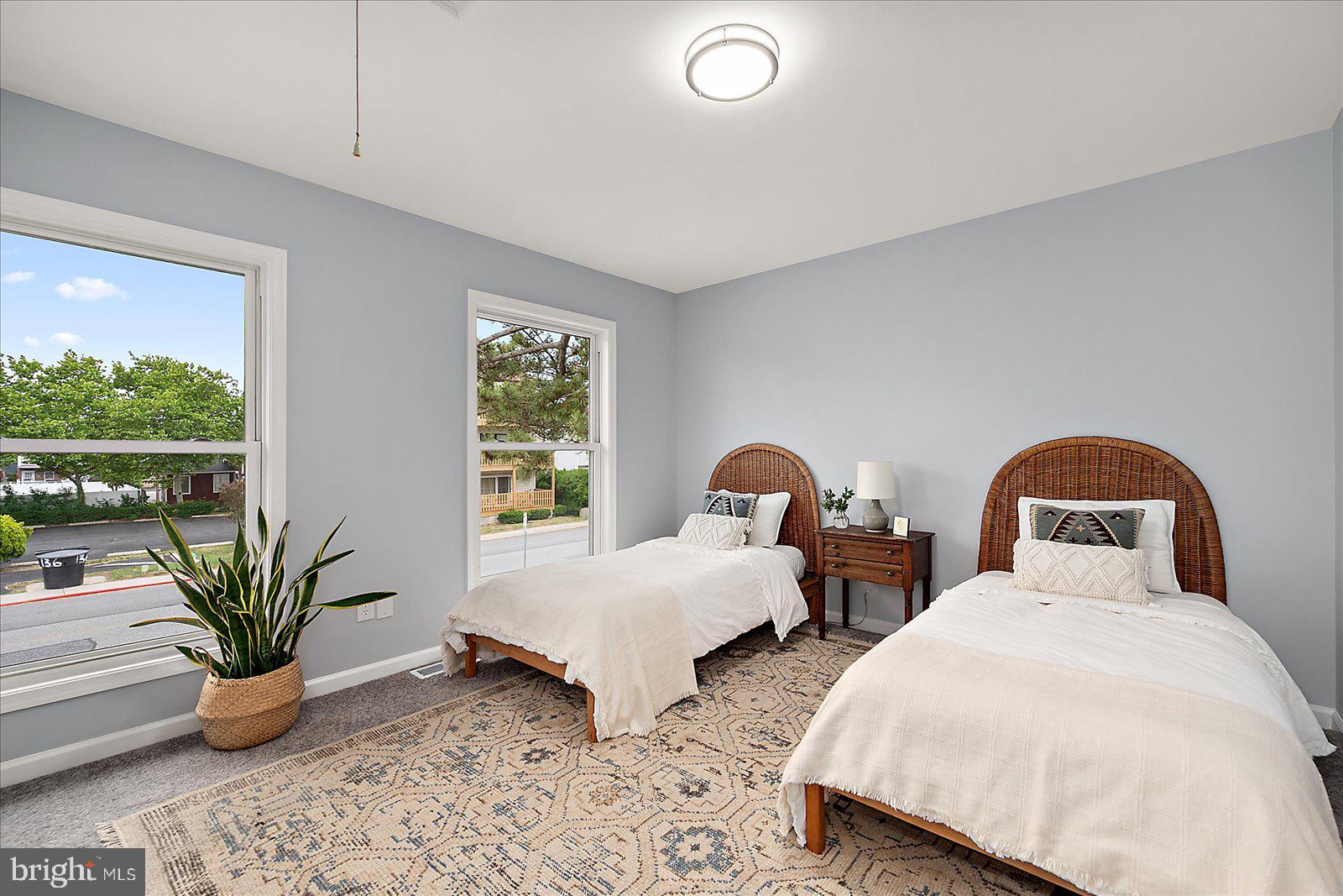 135 Jamestown Road, Unit 18A Ocean City, MD 21842 - Photo 33 of 63 a bedroom with two beds and potted plants with sky view