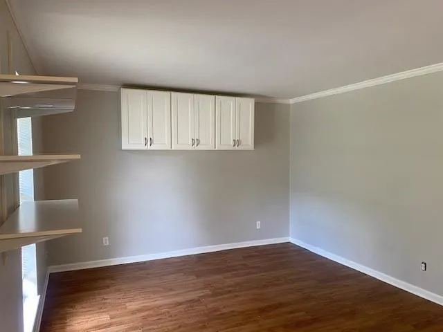 a view of a room with wooden floor