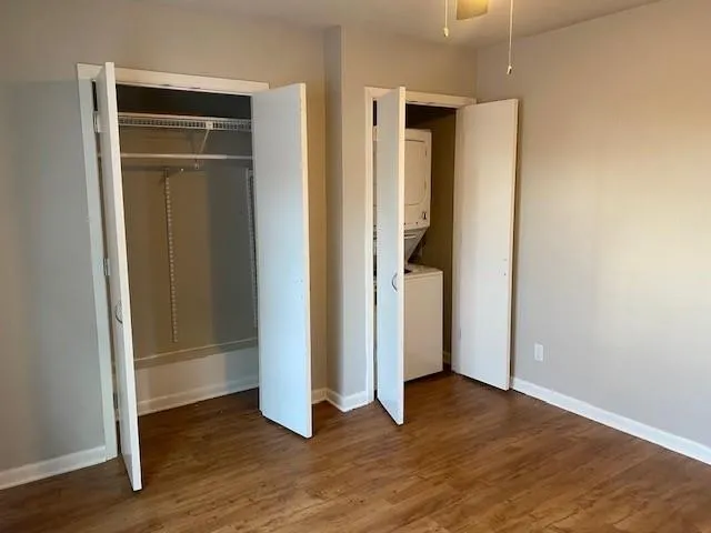 an entryway with wooden floor cabinet and a window
