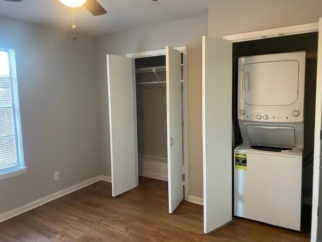 an empty room with wooden floor and a window