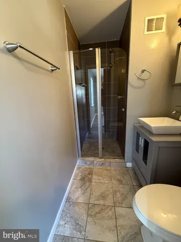 a bathroom with a toilet and a shower