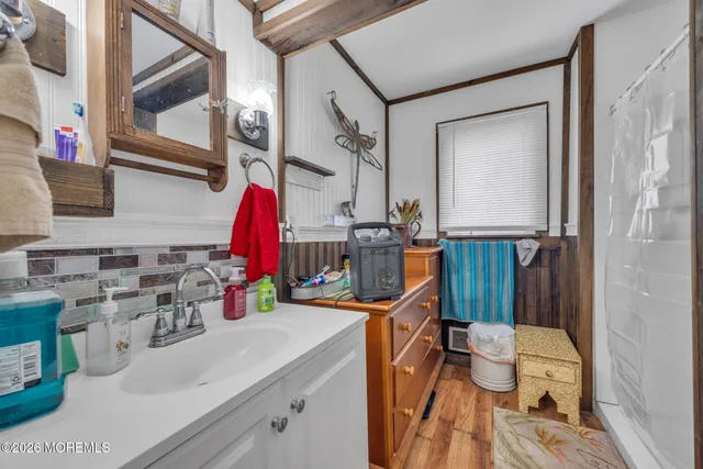 a bathroom with a sink vanity mirror and toilet