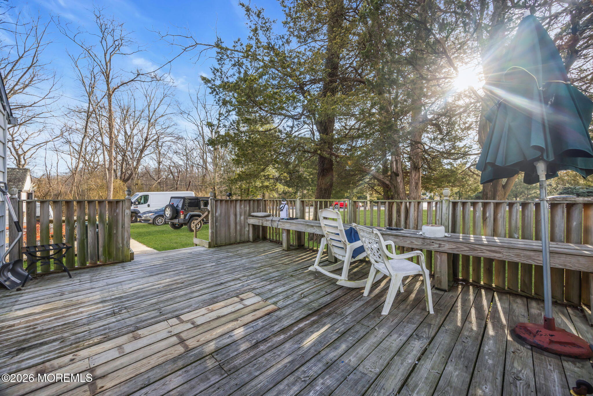 141 Jackson Mills Road Freehold, NJ 07728 - Photo 19 of 39 a view of a deck with table and chairs with wooden floor and fence