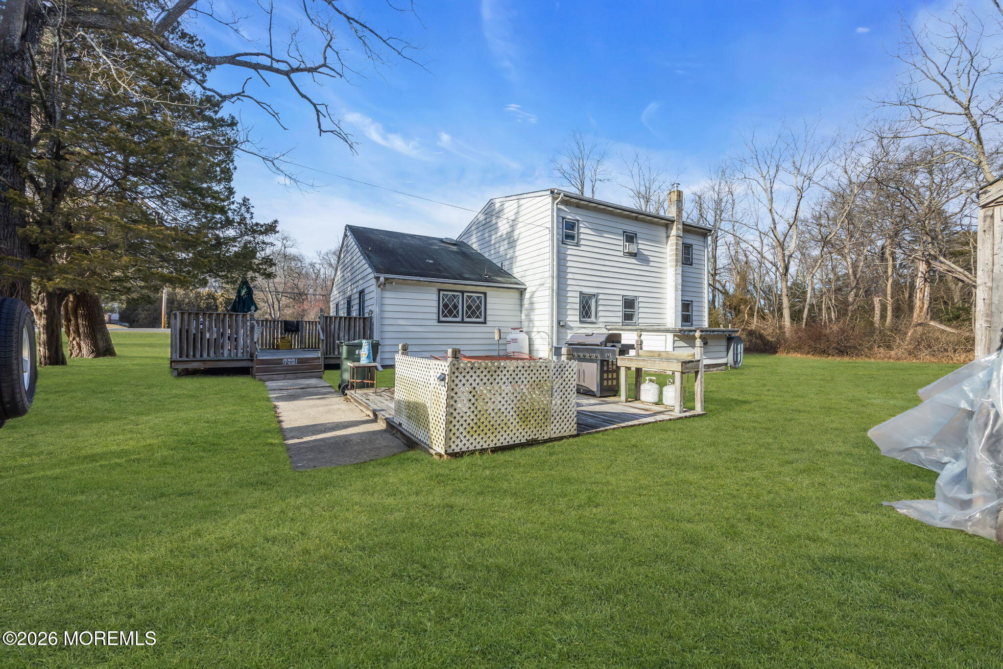 141 Jackson Mills Road Freehold, NJ 07728 - Photo 20 of 39 a front view of a house with garden and a sitting area