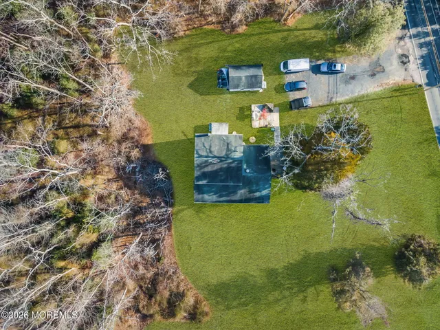 an aerial view of a house with a yard