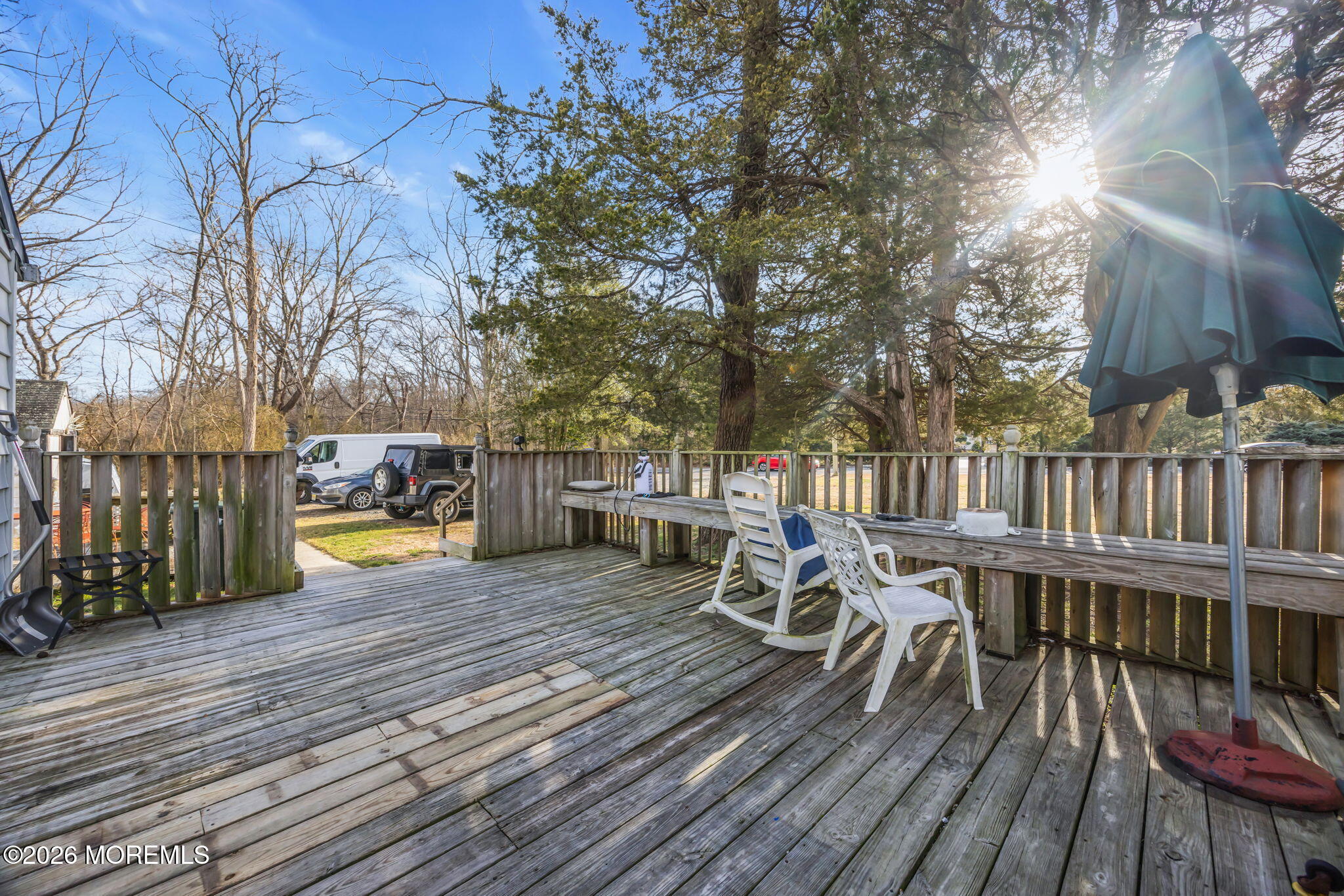 141 Jackson Mills Road Freehold, NJ 07728 - Photo 5 of 39 a view of a roof deck with table and chairs with wooden floor and fence