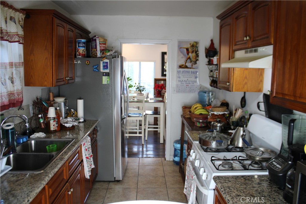 2412 West Alondra Boulevard Compton, CA 90220 - Photo 12 of 32 a kitchen with a stove and a refrigerator