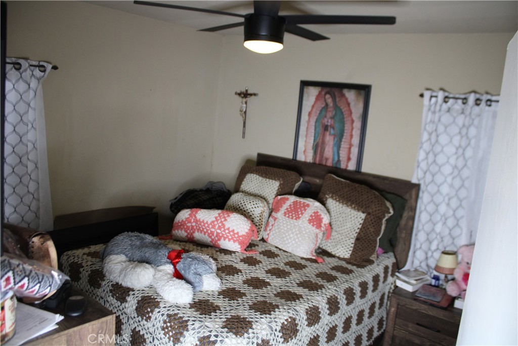 2412 West Alondra Boulevard Compton, CA 90220 - Photo 14 of 32 a bedroom with a bed and wooden floor