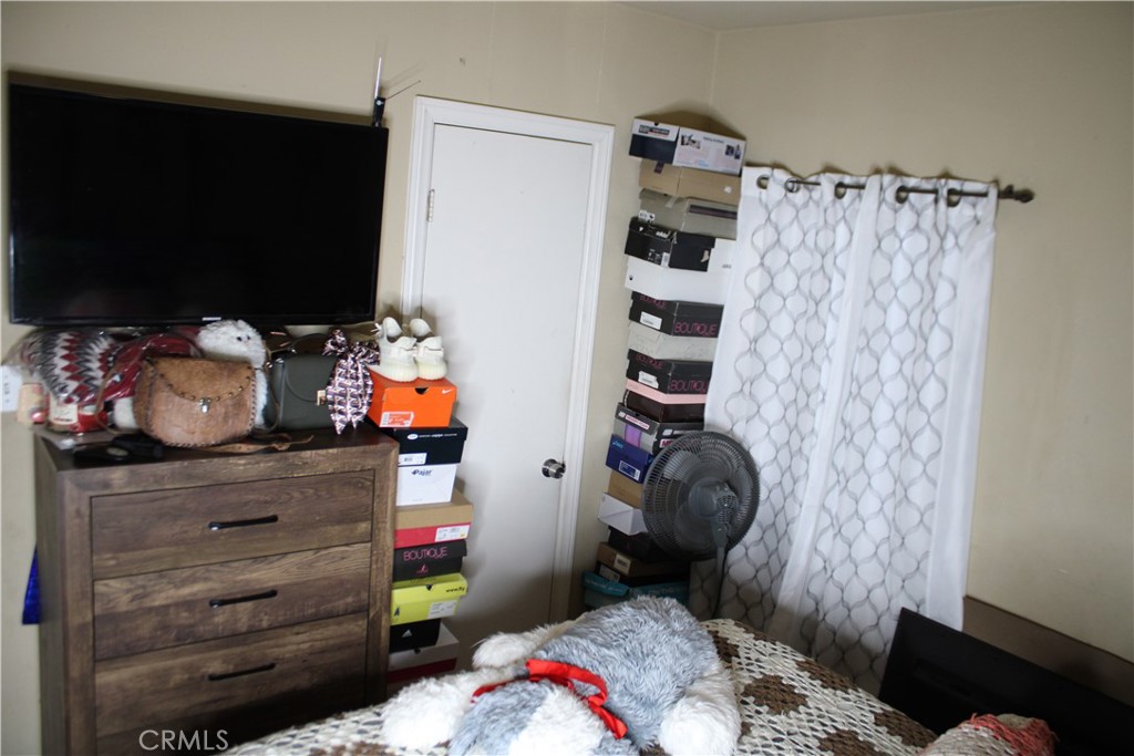 2412 West Alondra Boulevard Compton, CA 90220 - Photo 15 of 32 a bedroom with a bed and cabinets