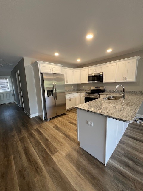 16 Cartertown Road, Unit A Scottsville, KY 42164 - Photo 3 of 15 a large kitchen with stainless steel appliances granite countertop a stove a sink dishwasher a microwave oven and a refrigerator with wooden floor