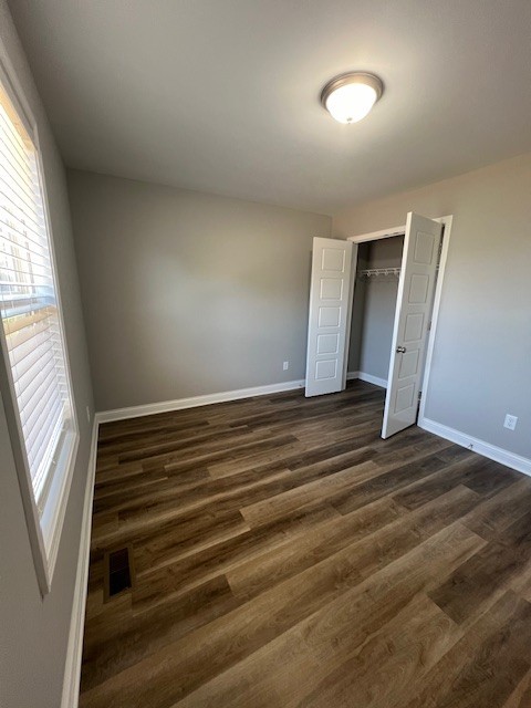 16 Cartertown Road, Unit A Scottsville, KY 42164 - Photo 7 of 15 an empty room with wooden floor and windows