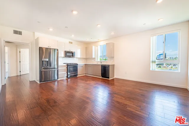 a view of a kitchen with a sink and a stove top oven