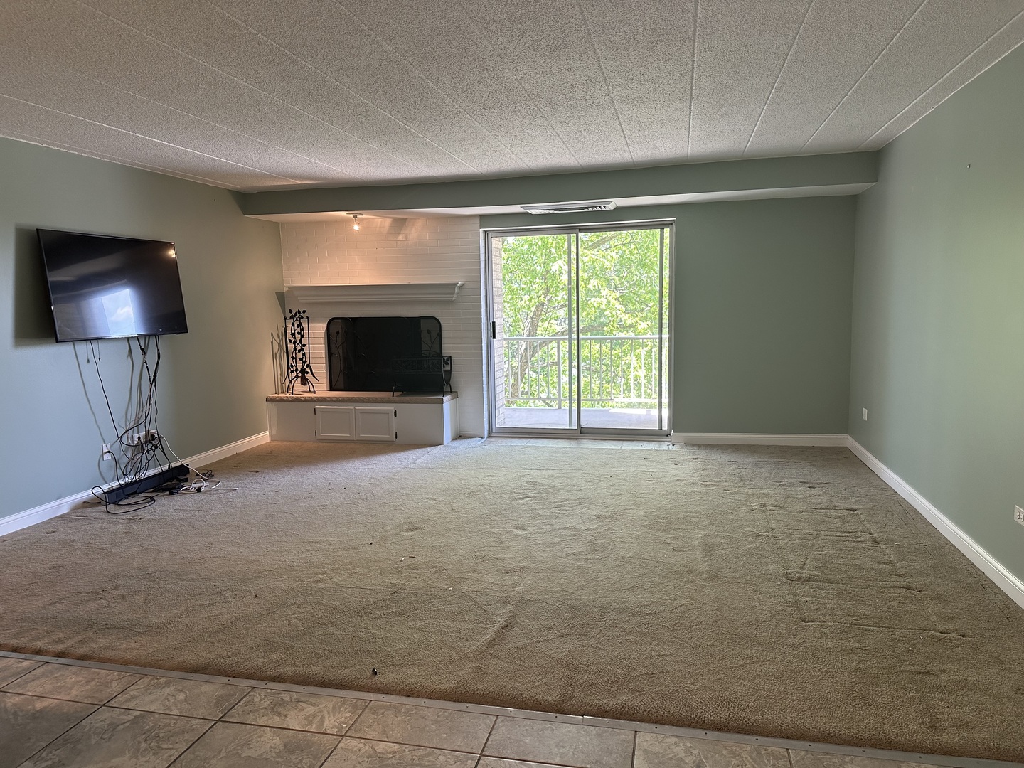 110 West Butterfield Road, Unit 402S Elmhurst, IL 60126 - Photo 5 of 17 a view of an empty room with a window and a fireplace