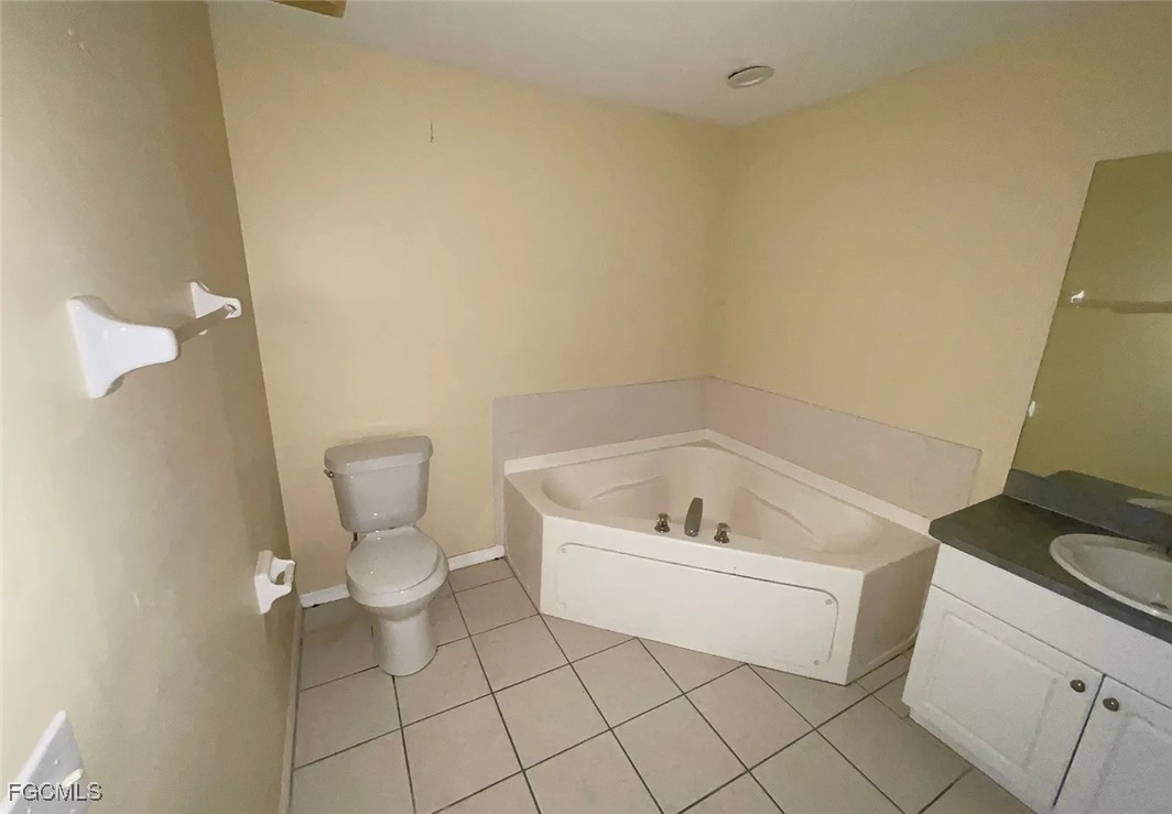 819 Abrams Boulevard Lehigh Acres, FL 33971 - Photo 7 of 10 a bathroom with a toilet and a bathtub