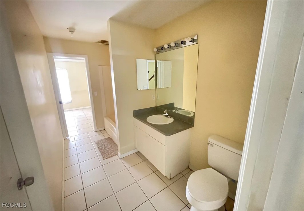 819 Abrams Boulevard Lehigh Acres, FL 33971 - Photo 10 of 10 a bathroom with a sink a toilet and shower