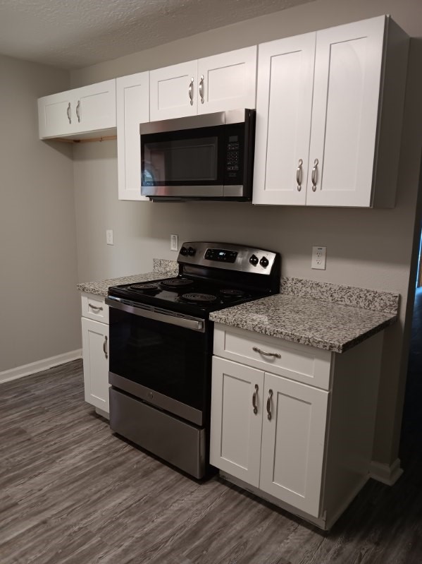 1102 Jackson Avenue Pasadena, TX 77506 - Photo 6 of 22 a kitchen with stainless steel appliances granite countertop a stove a microwave and oven