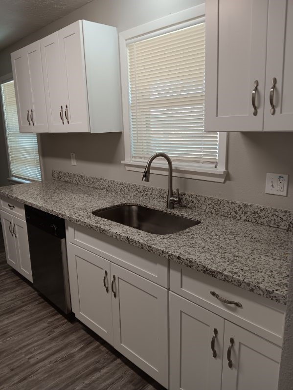1102 Jackson Avenue Pasadena, TX 77506 - Photo 7 of 22 a kitchen with granite countertop white cabinets and sink