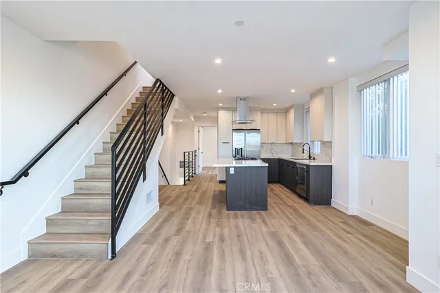 a kitchen with a sink stove and wooden cabinets