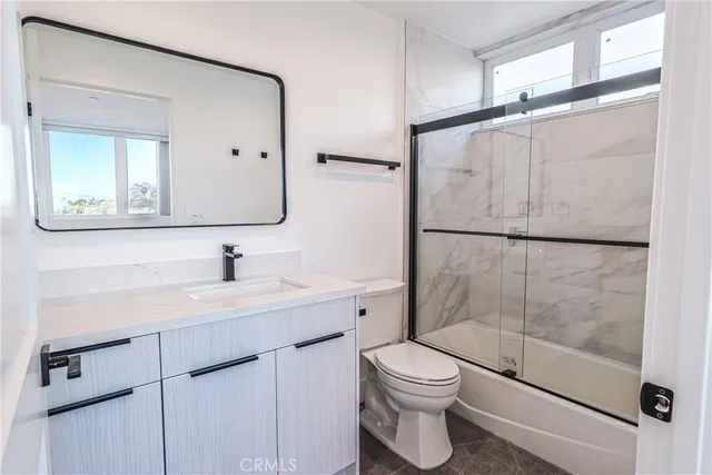 a view of a room with wooden floor and a sink