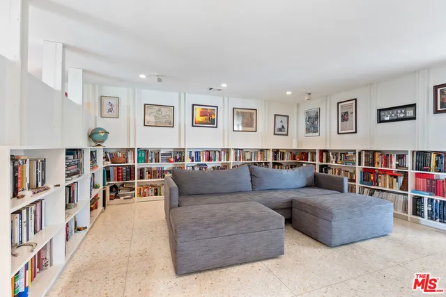 a living room with lots of furniture and book shelf
