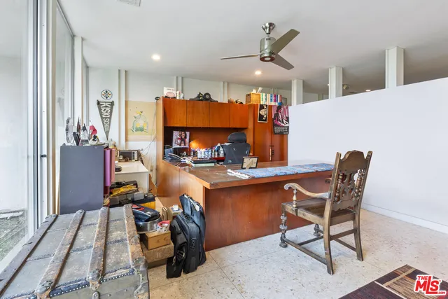 a room with stainless steel appliances kitchen island granite countertop furniture and a dining table