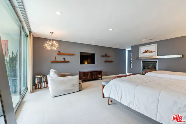 a spacious bedroom with a bed and a couch