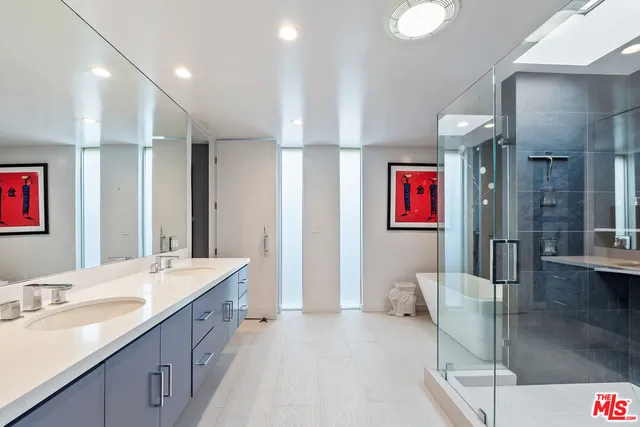 a spacious bathroom with a double vanity sink and a mirror