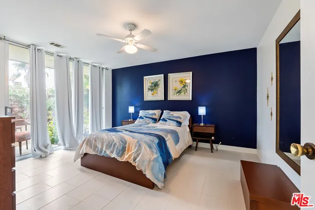 a bedroom with a bed and glass window