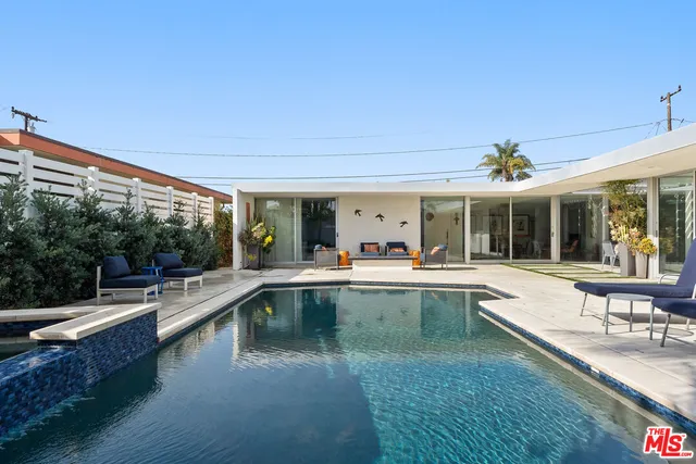 a view of a swimming pool and lounge chair