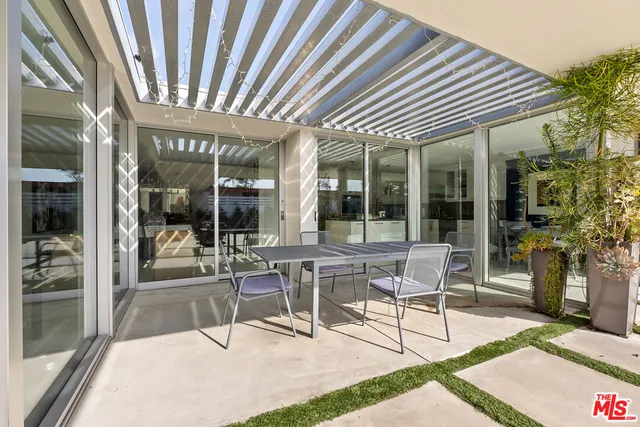 a patio with a table and chairs