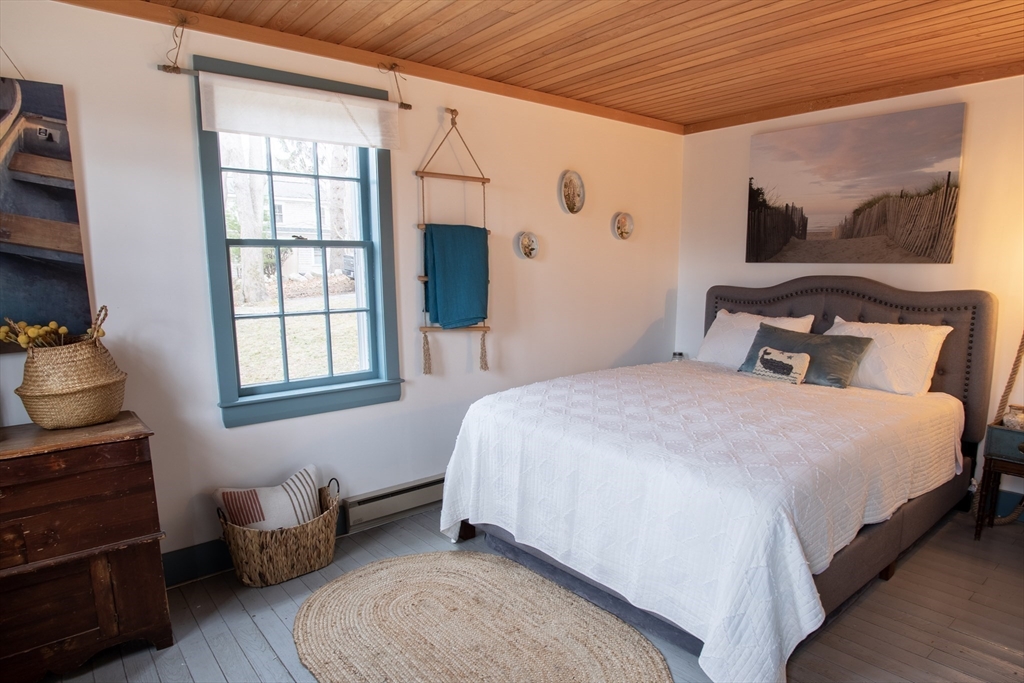 1825 Main Street Barnstable, MA 02668 - Photo 16 of 33 a bedroom with a bed and wooden floor