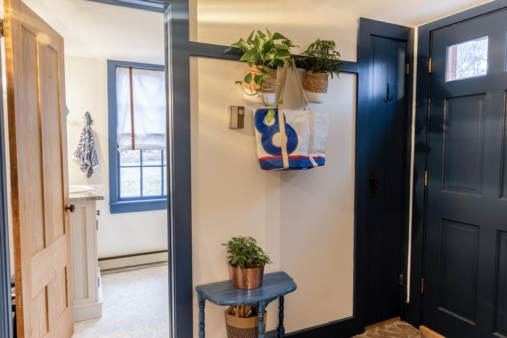 1825 Main Street Barnstable, MA 02668 - Photo 17 of 33 a view of a hallway with a potted plant on a table
