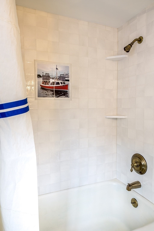 1825 Main Street Barnstable, MA 02668 - Photo 20 of 33 a bathroom with a tub and a shower