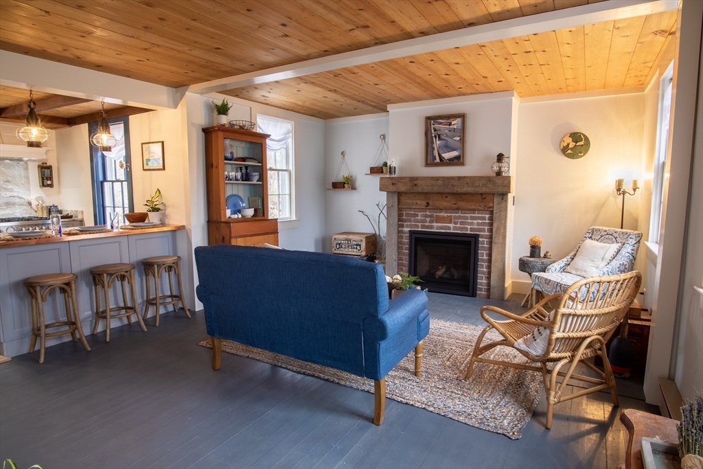 1825 Main Street Barnstable, MA 02668 - Photo 10 of 33 a living room with furniture and a fireplace