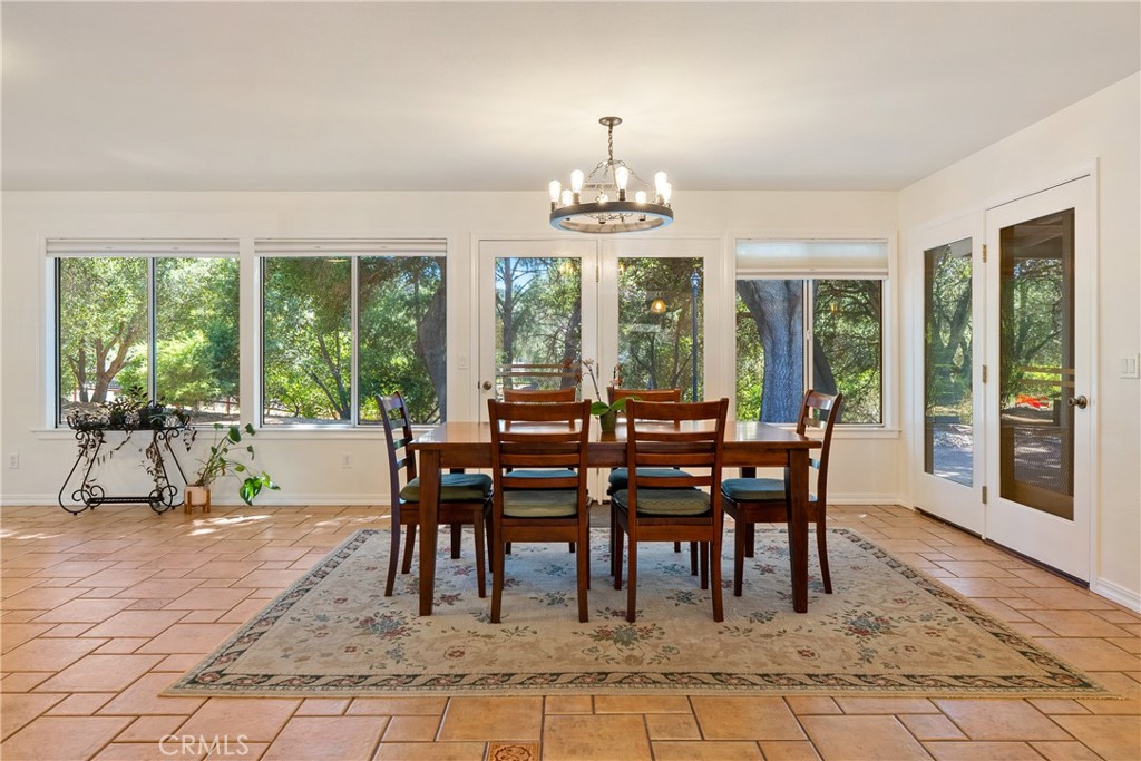 3388 Ramona Road Atascadero, CA 93422 - Photo 17 of 55 The dining area features a modern chandelier and French doors that lead out to the backyard.