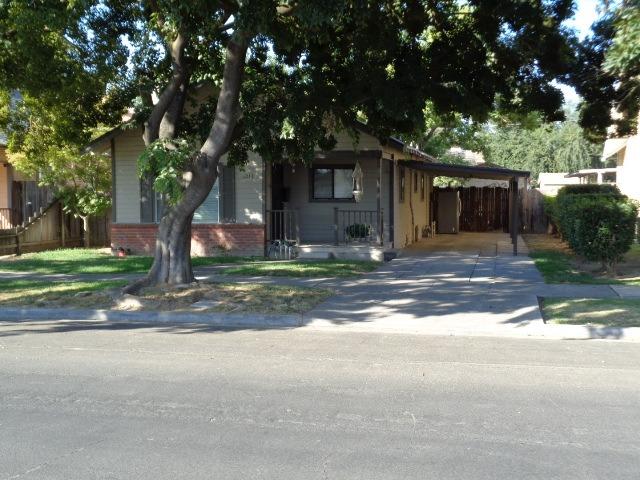 1213 M Street Reedley, CA 93654 - Photo 1 of 13 a front view of a house with yard and green space