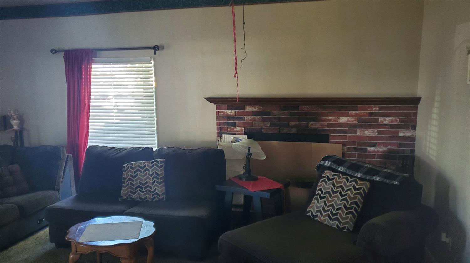 1213 M Street Reedley, CA 93654 - Photo 2 of 13 a living room with furniture and a window
