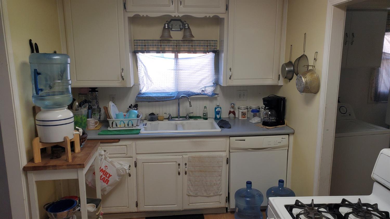 1213 M Street Reedley, CA 93654 - Photo 4 of 13 a kitchen with a sink cabinets and appliances