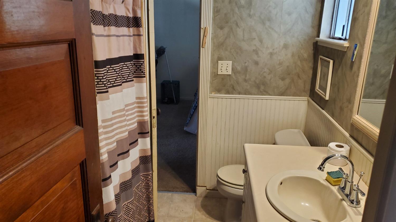 1213 M Street Reedley, CA 93654 - Photo 6 of 13 a bathroom with a toilet and a shower