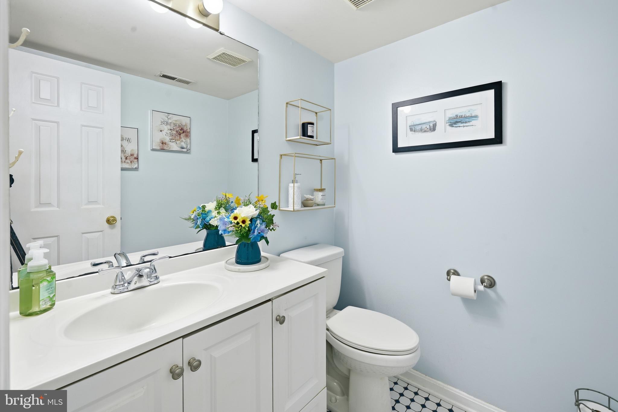 82 Sandyhook Road Berlin, MD 21811 - Photo 13 of 55 a bathroom with a sink mirror and toilet