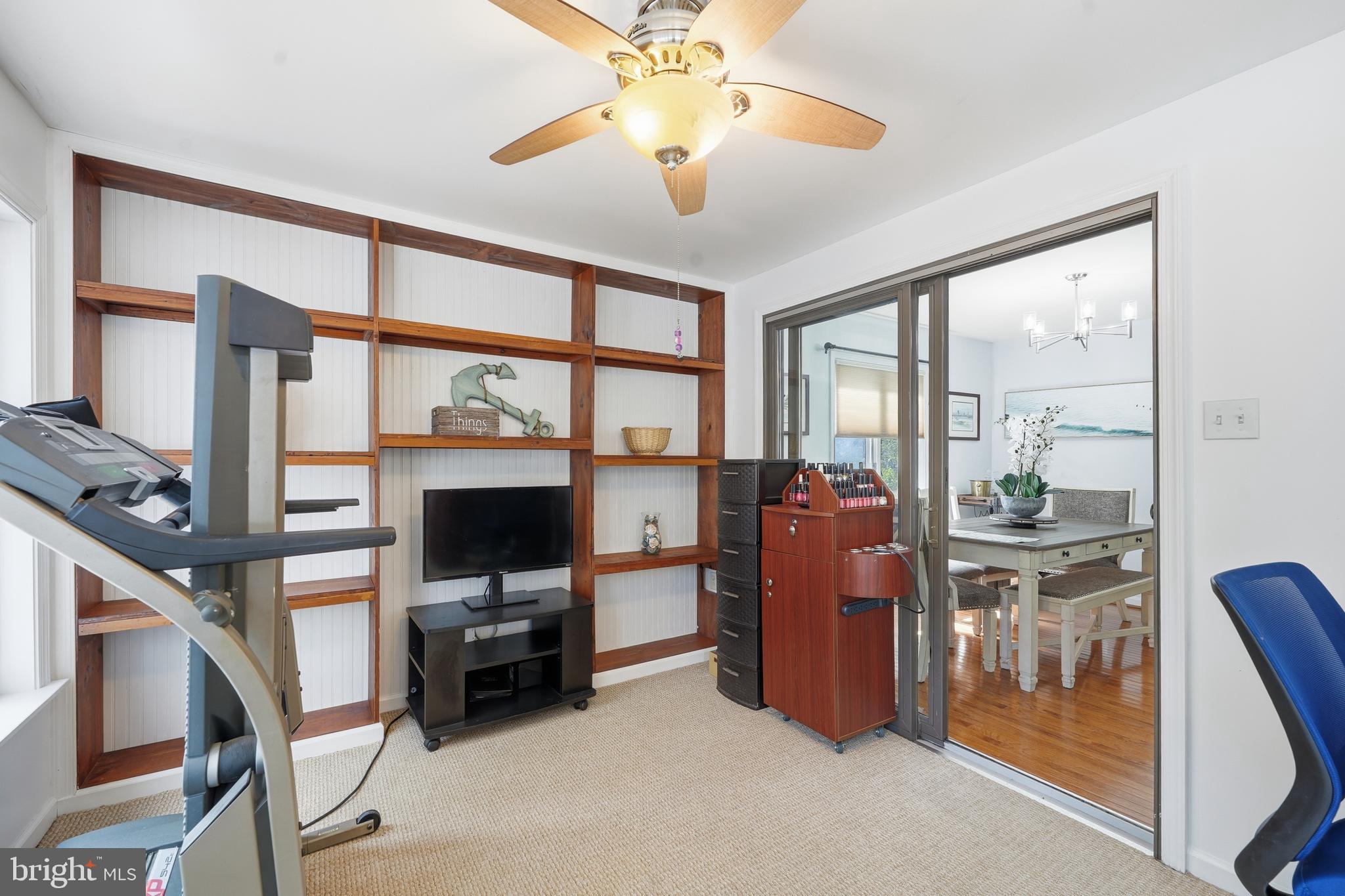 82 Sandyhook Road Berlin, MD 21811 - Photo 19 of 55 a living room with furniture a flat screen tv and a floor to ceiling window