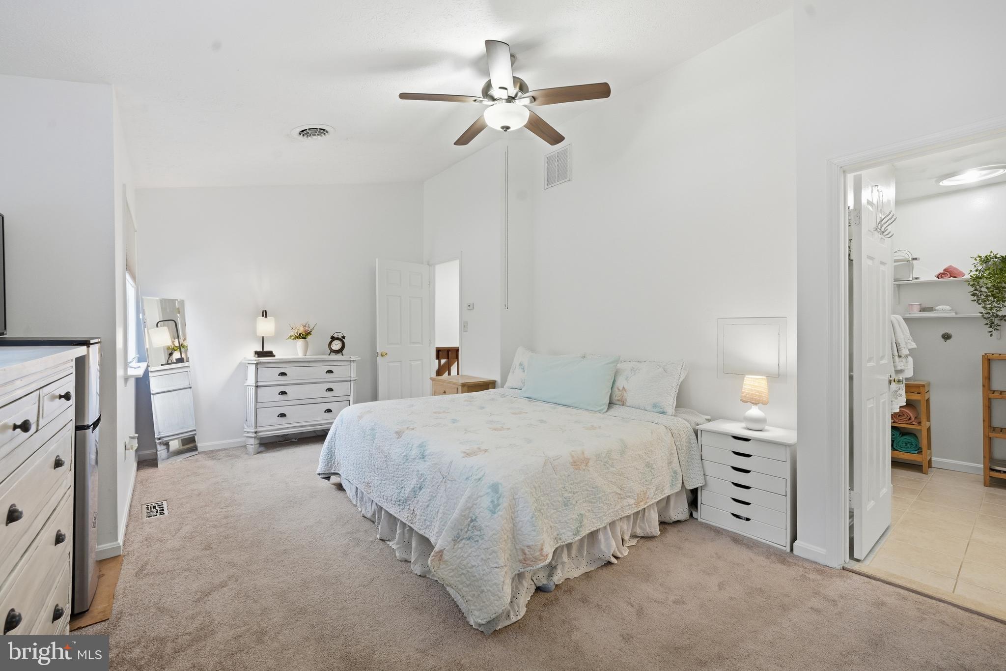 82 Sandyhook Road Berlin, MD 21811 - Photo 29 of 55 a spacious bedroom with a bed and a chandelier
