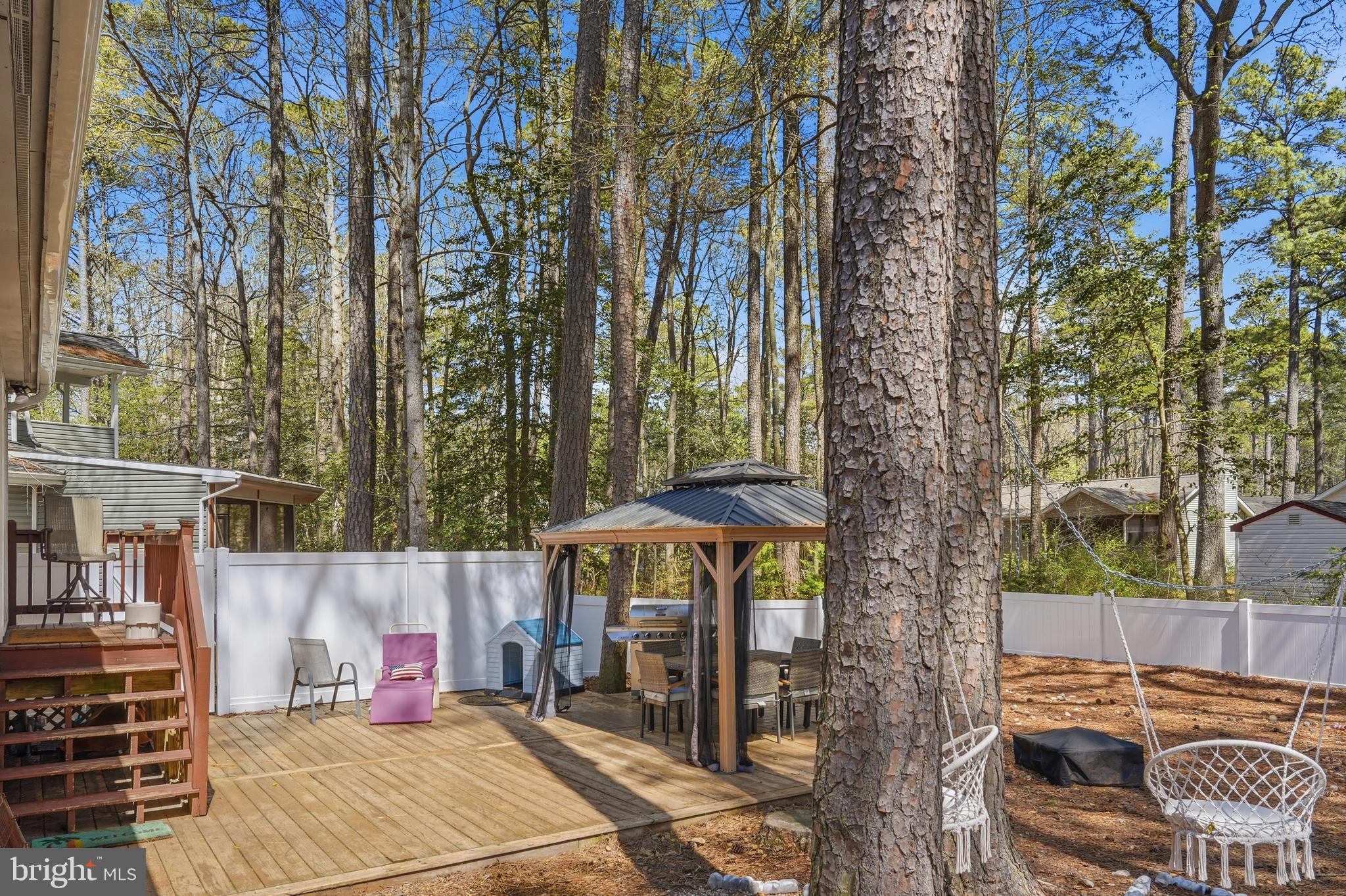 82 Sandyhook Road Berlin, MD 21811 - Photo 37 of 55 a view of a patio with table and chairs under an umbrella