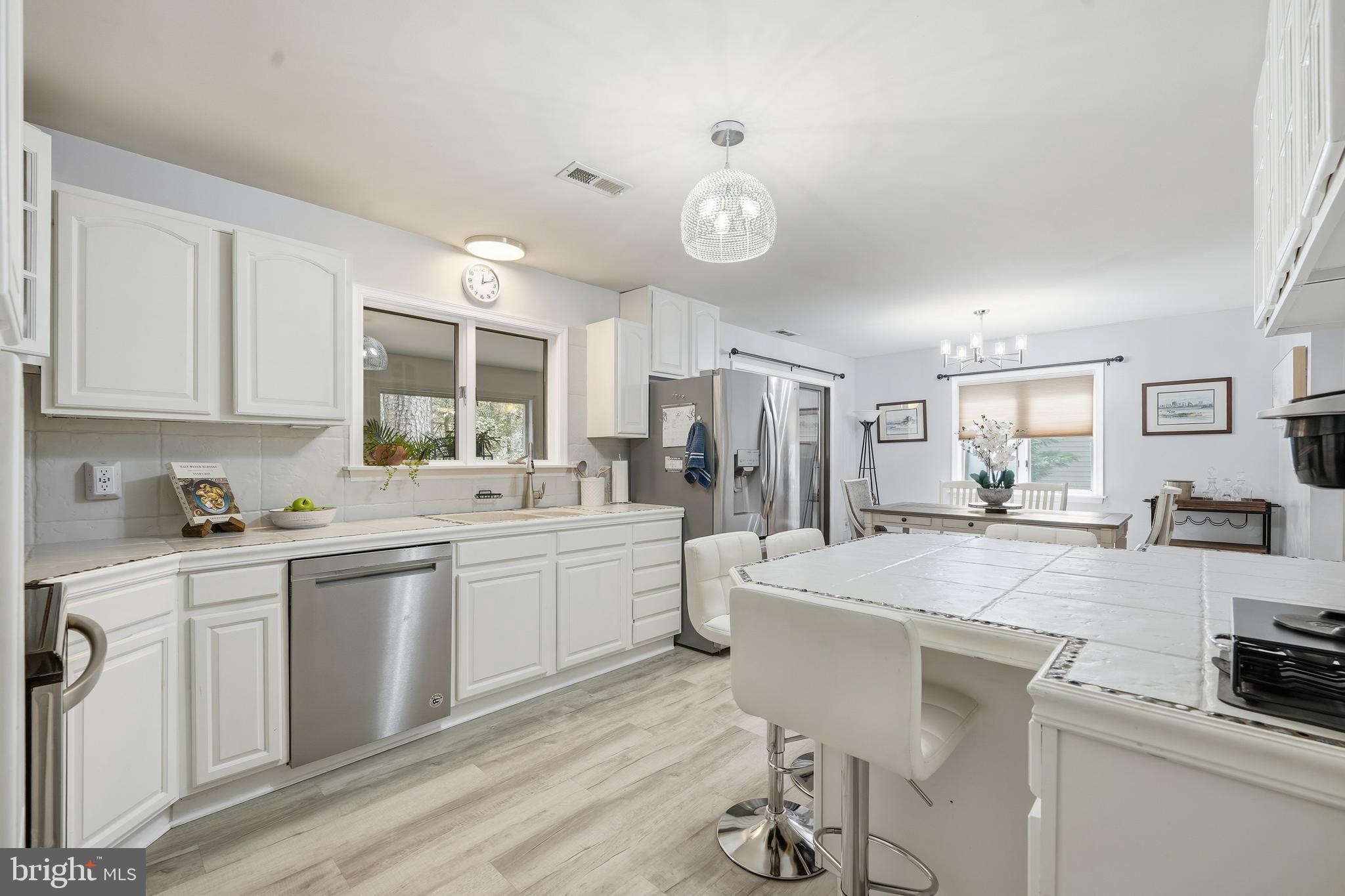 82 Sandyhook Road Berlin, MD 21811 - Photo 7 of 55 a kitchen with stainless steel appliances kitchen island granite countertop a sink and cabinets