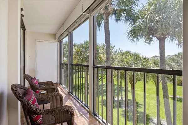 a balcony with furniture and a potted plant