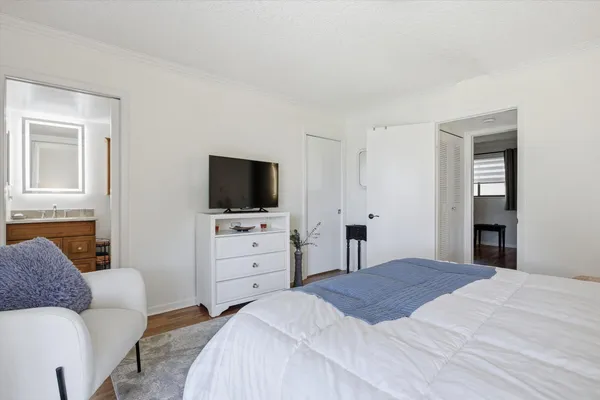 a bedroom with a bed and a flat screen tv
