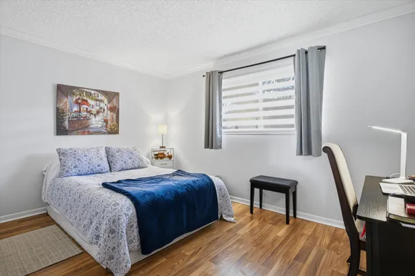 a bedroom with a bed a desk and chair